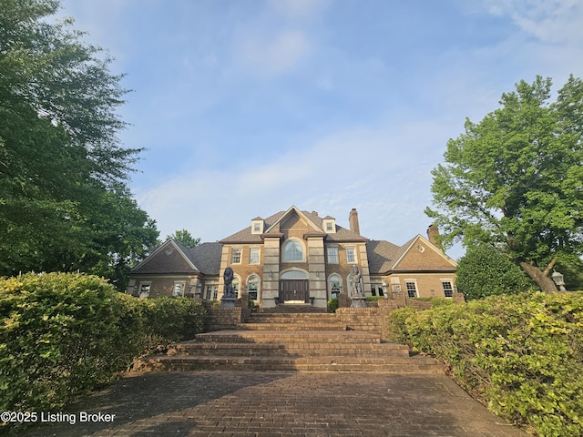 3501 Trinidad Ct, Lexington, KY 40509 - colonial inspired home featuring a chimney, stone siding, and brick siding