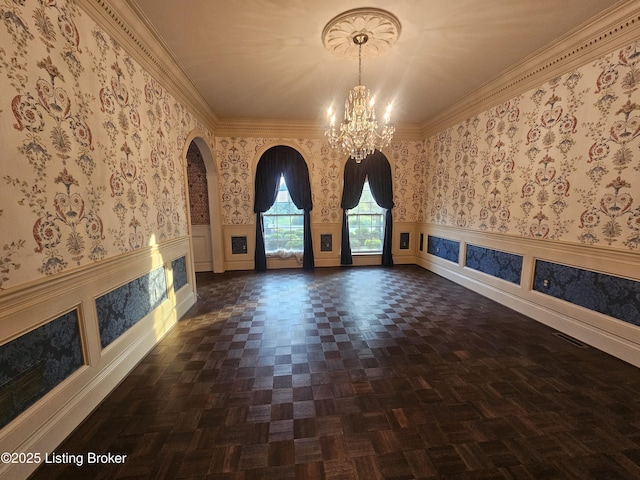 3501 Trinidad Ct, Lexington, KY 40509 - unfurnished living room with a chandelier, arched walkways, wainscoting, wallpapered walls, and crown molding