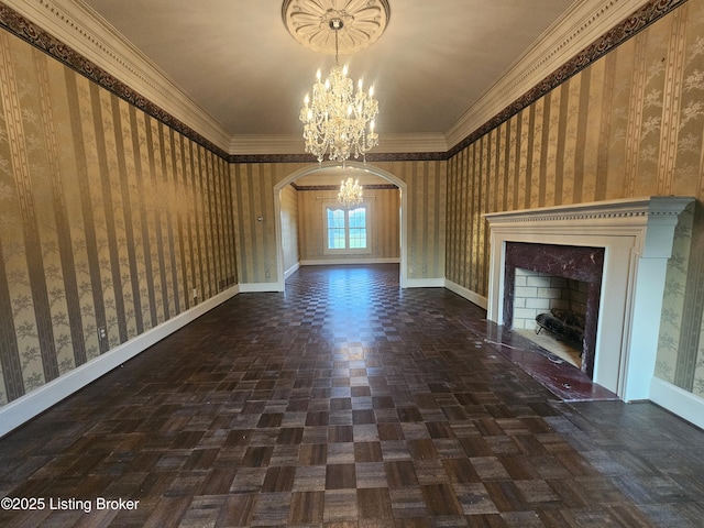 3501 Trinidad Ct, Lexington, KY 40509 - unfurnished living room featuring a fireplace, wallpapered walls, a chandelier, arched walkways, and ornamental molding