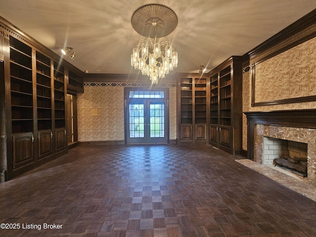 3501 Trinidad Ct, Lexington, KY 40509 - unfurnished living room with built in shelves, a chandelier, french doors, and a premium fireplace