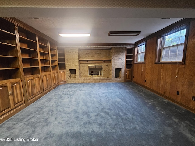 3501 Trinidad Ct, Lexington, KY 40509 - unfurnished living room featuring a fireplace, carpet, wood walls, built in shelves, and a textured ceiling