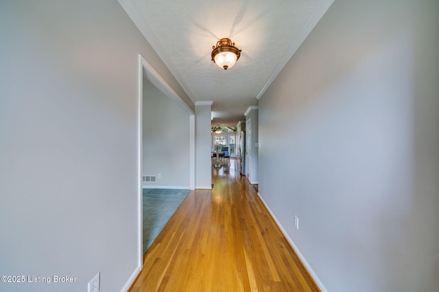 8415 Hurstbourne Woods Pl, Louisville, KY 40299 - corridor with light wood finished floors and crown molding