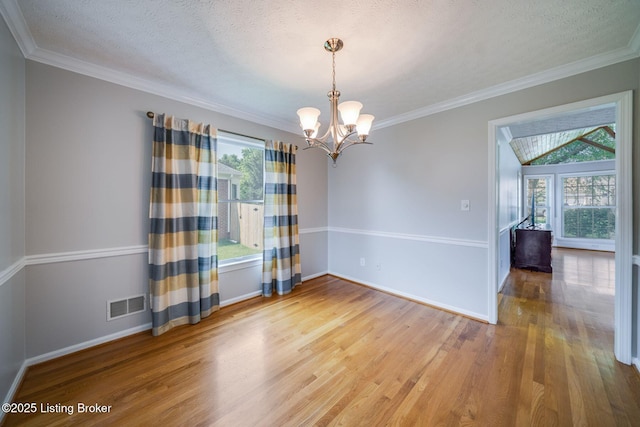 8415 Hurstbourne Woods Pl, Louisville, KY 40299 - spare room featuring healthy amount of natural light, wood finished floors, a chandelier, crown molding, and a textured ceiling