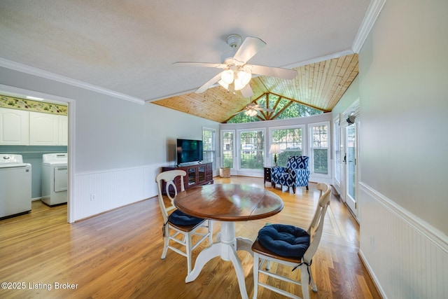 8415 Hurstbourne Woods Pl, Louisville, KY 40299 - dining area with washing machine and clothes dryer, a ceiling fan, light wood finished floors, a wainscoted wall, and lofted ceiling