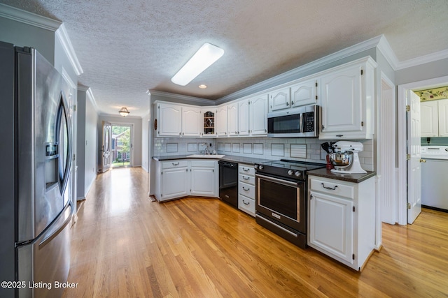 8415 Hurstbourne Woods Pl, Louisville, KY 40299 - kitchen featuring appliances with stainless steel finishes, dark countertops, light wood-style floors, white cabinets, and ornamental molding