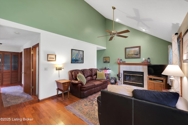 79 Meadow Lake Dr, Taylorsville, KY 40071 - living area featuring vaulted ceiling, light wood-style flooring, a tile fireplace, and ceiling fan