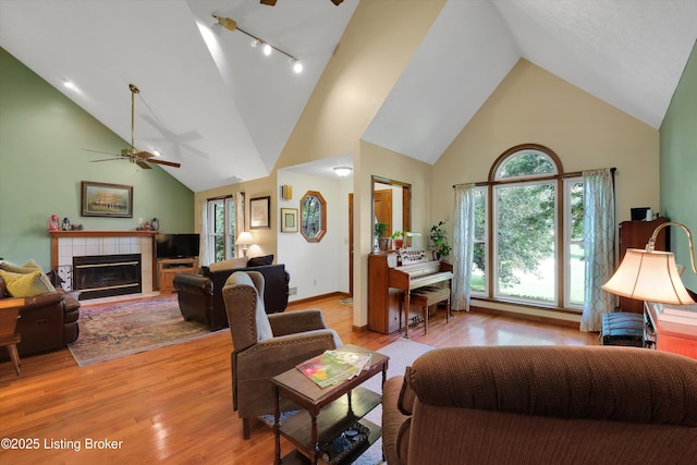 79 Meadow Lake Dr, Taylorsville, KY 40071 - living area with a ceiling fan, high vaulted ceiling, a fireplace, light wood-style floors, and plenty of natural light