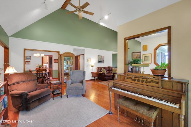 79 Meadow Lake Dr, Taylorsville, KY 40071 - living room with rail lighting, wood finished floors, ceiling fan, a chandelier, and high vaulted ceiling