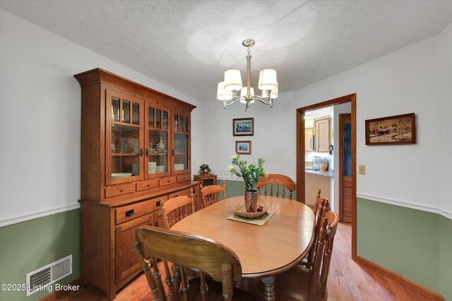 79 Meadow Lake Dr, Taylorsville, KY 40071 - dining area with a chandelier, light wood-style floors, and a textured ceiling