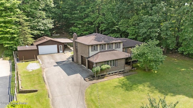 2312 Blevins Gap Rd, Louisville, KY 40272 - view of front of home with a garage, a front lawn, an outbuilding, a chimney, and a shingled roof