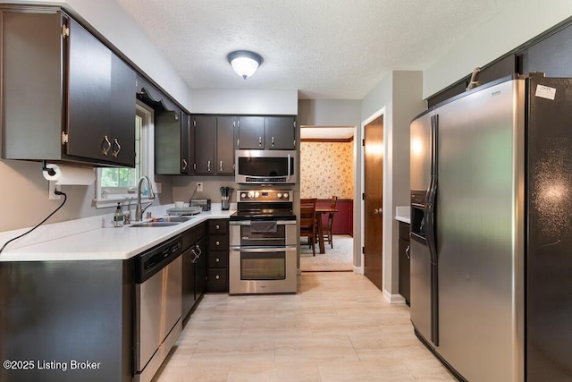 2312 Blevins Gap Rd, Louisville, KY 40272 - kitchen featuring stainless steel appliances, light countertops, and a textured ceiling
