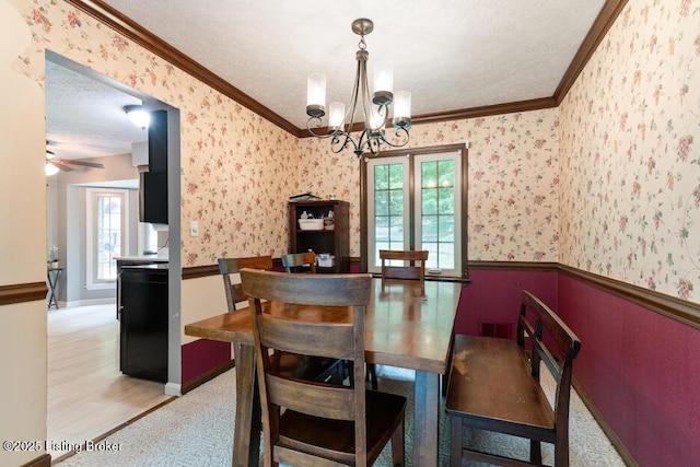 2312 Blevins Gap Rd, Louisville, KY 40272 - dining area with a wainscoted wall, crown molding, wallpapered walls, healthy amount of natural light, and a chandelier