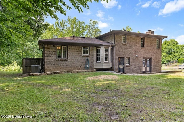 2312 Blevins Gap Rd, Louisville, KY 40272 - rear view of house with brick siding, a chimney, and a lawn