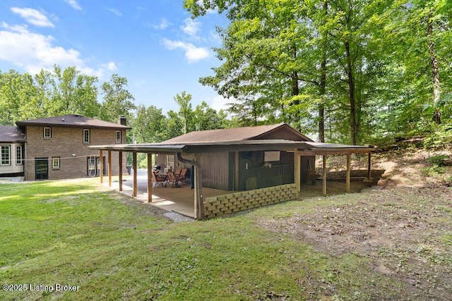 2312 Blevins Gap Rd, Louisville, KY 40272 - back of property with a chimney, a lawn, and a patio