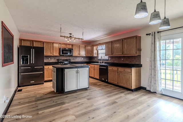 95 Sunny Meadows Dr, Vine Grove, KY 40175 - kitchen with black appliances, dark countertops, light wood finished floors, decorative backsplash, and a textured ceiling