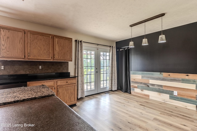 95 Sunny Meadows Dr, Vine Grove, KY 40175 - kitchen with french doors, dark countertops, light wood-type flooring, hanging light fixtures, and a textured ceiling