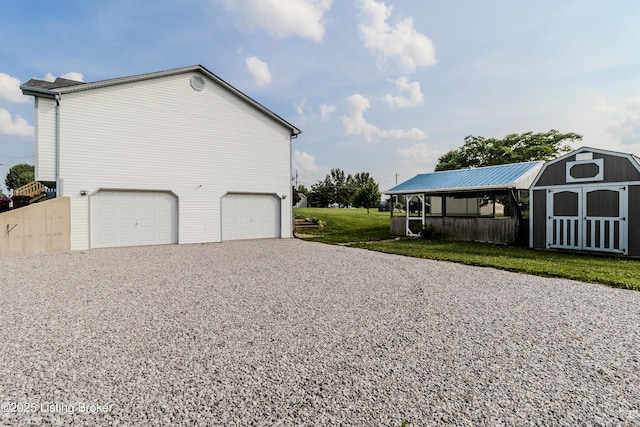 95 Sunny Meadows Dr, Vine Grove, KY 40175 - view of home's exterior with an attached garage, driveway, a shed, and a lawn