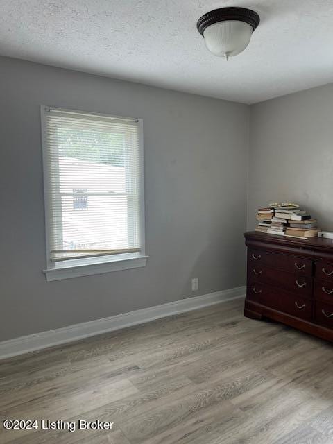 1008 Walter Ave, Louisville, KY 40215 - unfurnished bedroom featuring light wood-style flooring and baseboards