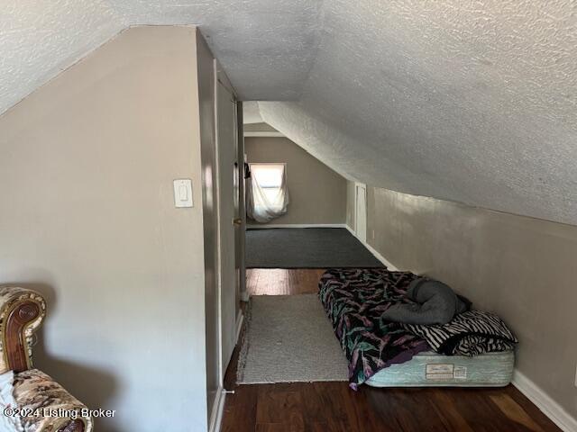 1008 Walter Ave, Louisville, KY 40215 - additional living space with a textured ceiling, wood finished floors, and lofted ceiling