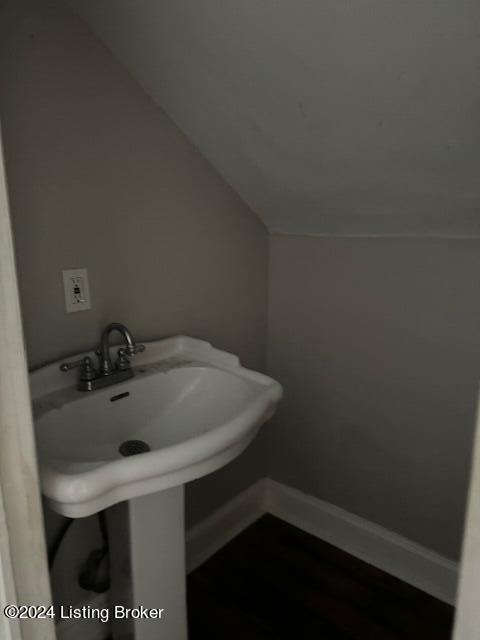 1008 Walter Ave, Louisville, KY 40215 - bathroom featuring baseboards and lofted ceiling