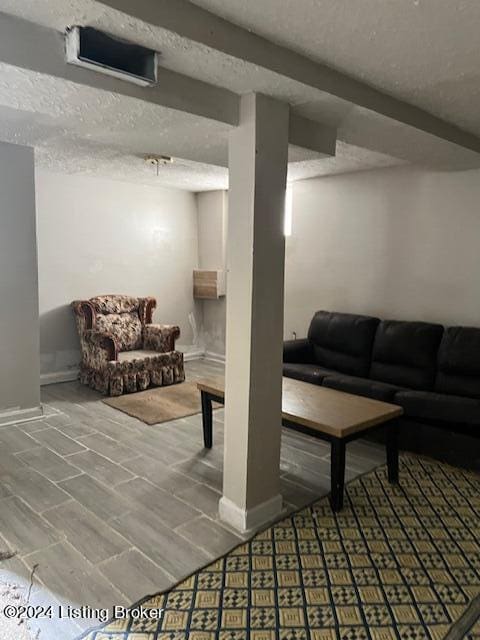 1008 Walter Ave, Louisville, KY 40215 - finished below grade area featuring a textured ceiling and baseboards