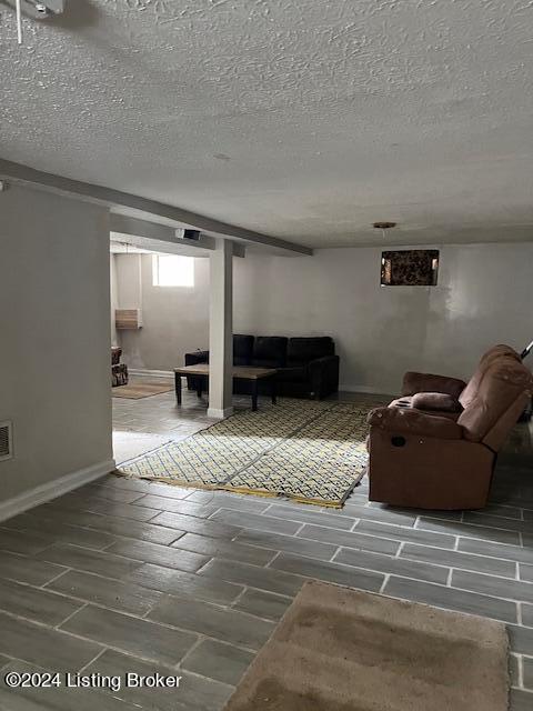 1008 Walter Ave, Louisville, KY 40215 - living room with a textured ceiling and wood tiled floors