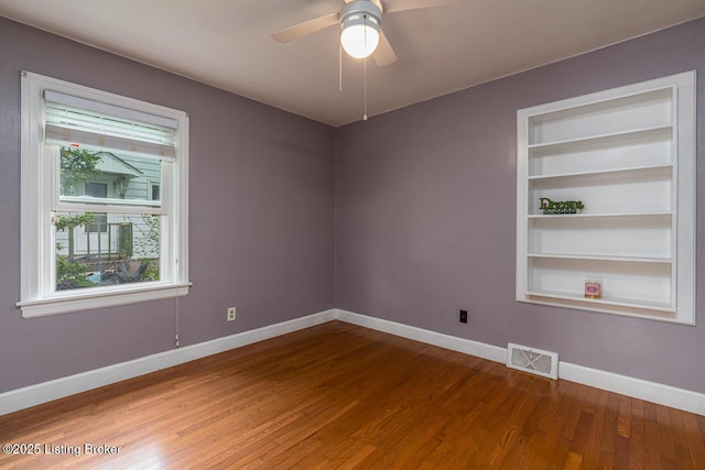 329 Robin Rd, Elizabethtown, KY 42701 - spare room with wood finished floors, ceiling fan, and built in shelves