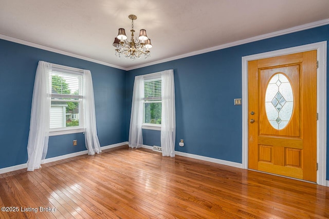 329 Robin Rd, Elizabethtown, KY 42701 - entrance foyer with a chandelier, healthy amount of natural light, light wood finished floors, and ornamental molding