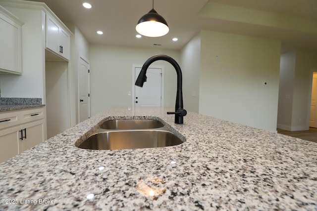 838 Otter Creek Rd, Vine Grove, KY 40175 - kitchen view of recessed lighting, light stone countertops, white cabinetry, and hanging light fixtures