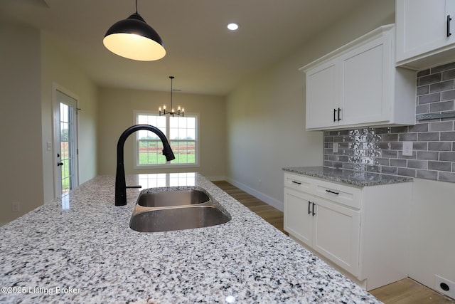838 Otter Creek Rd, Vine Grove, KY 40175 - kitchen featuring light stone countertops, a chandelier, decorative backsplash, white cabinets, and recessed lighting