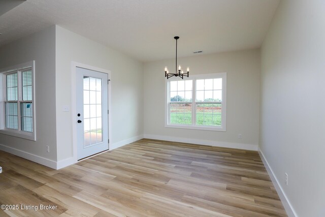 838 Otter Creek Rd, Vine Grove, KY 40175 - unfurnished dining area with light wood finished floors and a chandelier