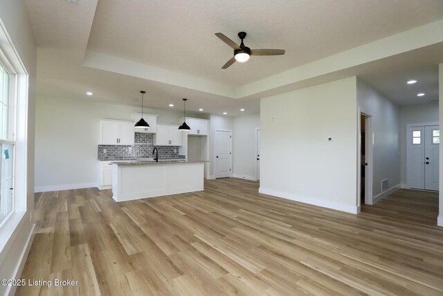 838 Otter Creek Rd, Vine Grove, KY 40175 - unfurnished living room with a ceiling fan, light wood-style flooring, recessed lighting, and a raised ceiling
