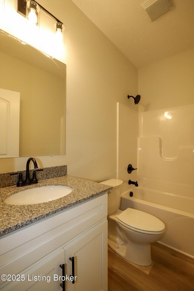 838 Otter Creek Rd, Vine Grove, KY 40175 - full bath featuring wood finished floors, vanity, and bathtub / shower combination