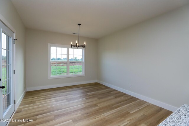 838 Otter Creek Rd, Vine Grove, KY 40175 - unfurnished room featuring a chandelier and light wood-type flooring
