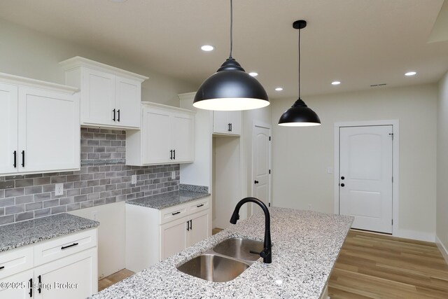 838 Otter Creek Rd, Vine Grove, KY 40175 - kitchen featuring light stone counters, white cabinets, and recessed lighting