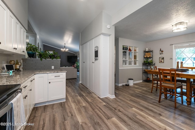 8504 Bambi Way, Louisville, KY 40214 - kitchen with stainless steel range with electric stovetop, a chandelier, dark wood-type flooring, white cabinetry, and lofted ceiling