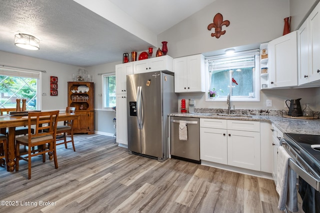 8504 Bambi Way, Louisville, KY 40214 - kitchen with appliances with stainless steel finishes, light wood-style flooring, white cabinets, light stone countertops, and a textured ceiling