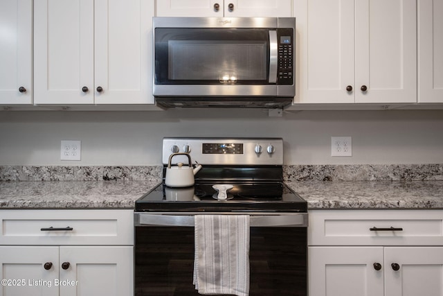 8504 Bambi Way, Louisville, KY 40214 - kitchen featuring appliances with stainless steel finishes, white cabinetry, and light stone counters