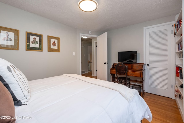 8504 Bambi Way, Louisville, KY 40214 - bedroom featuring light wood finished floors and a textured ceiling