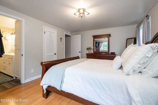 8504 Bambi Way, Louisville, KY 40214 - bedroom with light wood-style flooring, ensuite bathroom, and a closet