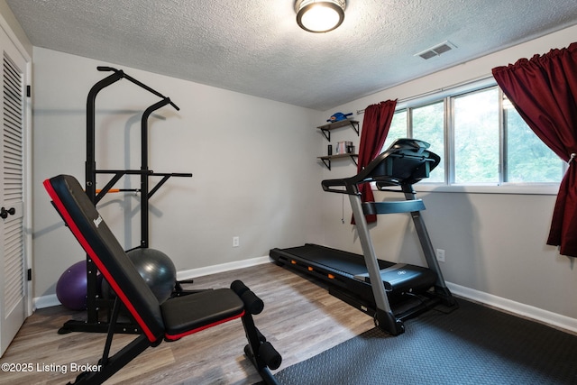 8504 Bambi Way, Louisville, KY 40214 - exercise area featuring a textured ceiling and wood finished floors