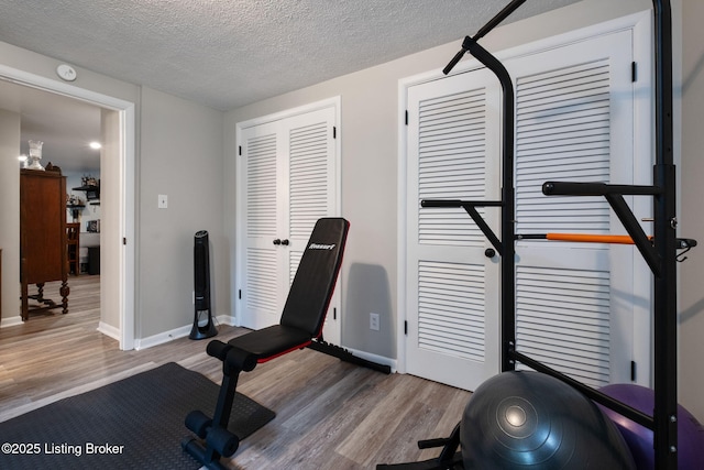 8504 Bambi Way, Louisville, KY 40214 - workout room with wood finished floors and a textured ceiling