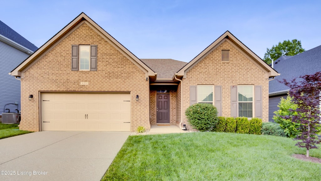 125 Belden Trl, Louisville, KY 40245 - view of front of property with concrete driveway, a front lawn, and brick siding