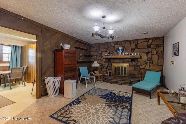 2149 Shrewsbury Rd, Leitchfield, KY 42754 - living room with a chandelier, a textured ceiling, a stone fireplace, and wood walls