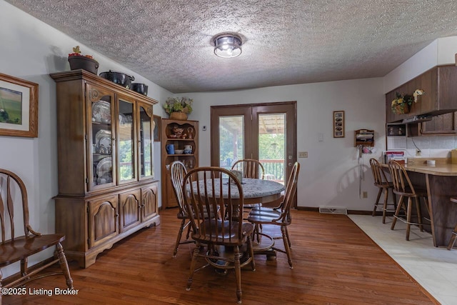 2149 Shrewsbury Rd, Leitchfield, KY 42754 - dining space featuring light wood finished floors and a textured ceiling