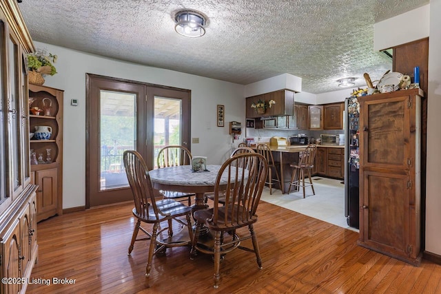 2149 Shrewsbury Rd, Leitchfield, KY 42754 - dining room featuring light wood-style floors, a textured ceiling, and french doors