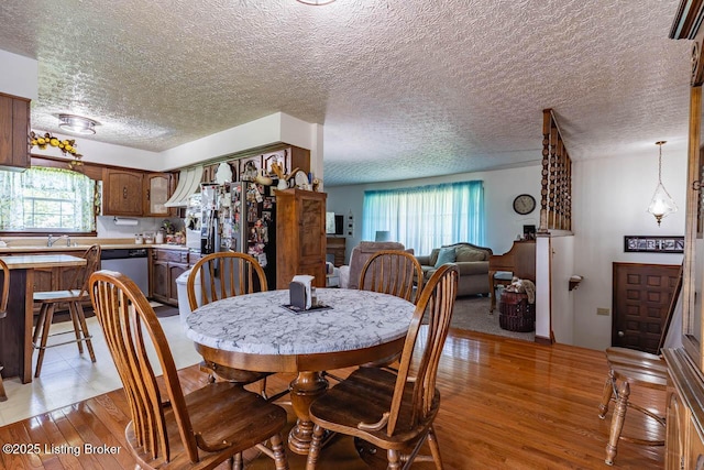 2149 Shrewsbury Rd, Leitchfield, KY 42754 - dining area with light wood-style floors and a textured ceiling