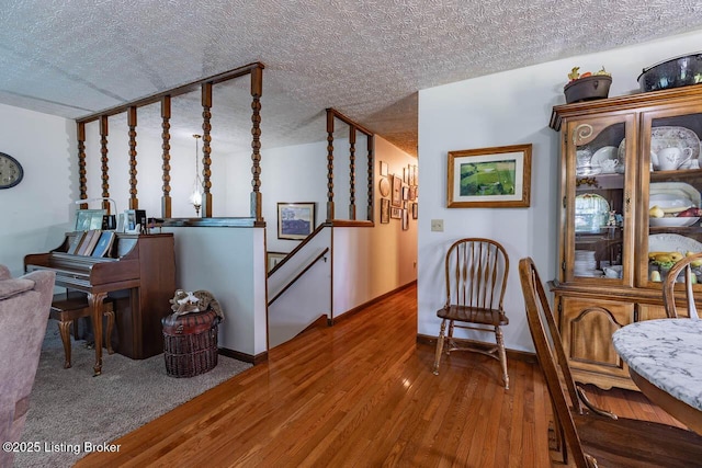 2149 Shrewsbury Rd, Leitchfield, KY 42754 - living area with wood finished floors, an upstairs landing, and a textured ceiling