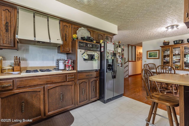 2149 Shrewsbury Rd, Leitchfield, KY 42754 - kitchen with white appliances, ventilation hood, a textured ceiling, light countertops, and tasteful backsplash