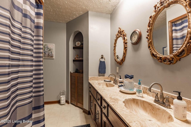 2149 Shrewsbury Rd, Leitchfield, KY 42754 - bathroom featuring a textured ceiling, double vanity, tile patterned flooring, and built in shelves